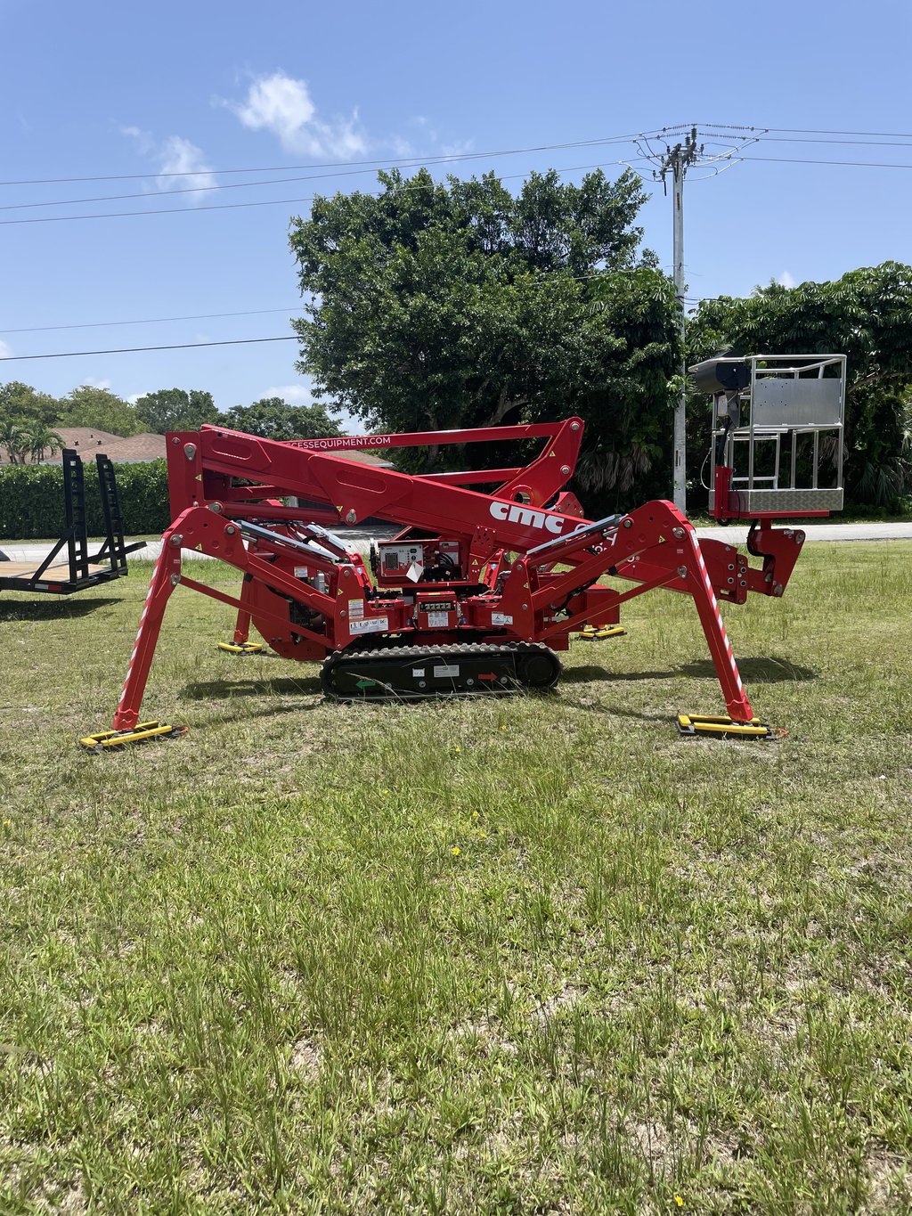 Spider lift reaching high canopy for safe trimming
